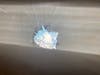 The bullet hole found in a window at Maloney High School in Meriden.