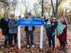 Tom Conroy stands behind his “Conroy Corner” sign with, from left, wife Barbara Conroy, sister Lynn Jaqua, and daughters Colleen Innamorato, holding son Charlie Innamorato, 2, and Kristina Conroy, holding niece Grace Innamorato, 3 months.