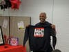 Darryl "DMC" McDaniels holds a custom-made Bailey Eagles shirt that mimics the Run-DMC logo Tuesday at Bailey Middle School in West Haven.