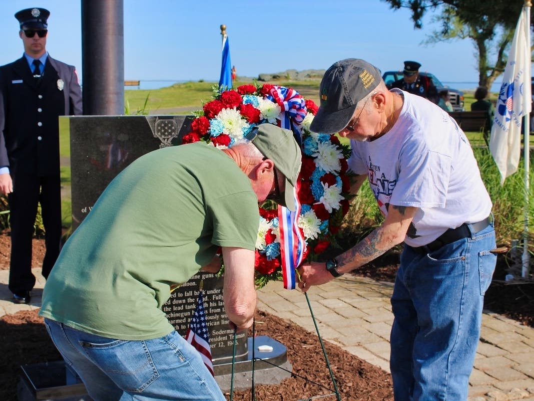 West Haven Vietnam Army veterans Mark Levine, left, and Al Beck Sr. lay a wreath at the base of the William A. Soderman Memorial in Bradley Point Park during the city’s Phase 15 dedication of the brick Veterans Walk of Honor on Saturday, May 27.