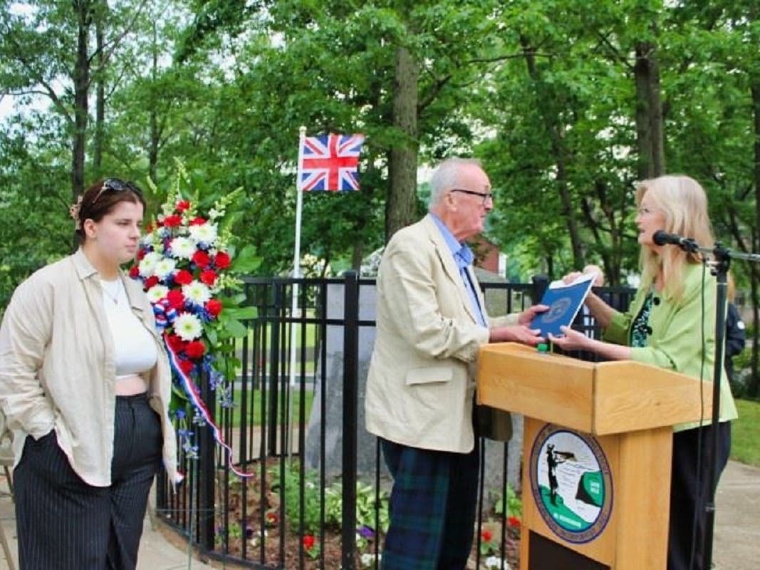 West Haven Mayor Nancy R. Rossi, right, presents William Campbell descendants George F. Campbell, 70, and his daughter, Miriam Campbell, 17, with a proclamation declaring “Adjutant William Campbell Day” in West Haven on Thursday, June 8. 