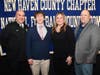 Xavier's Noah Barnhart, of Wallingford, with coach Andy Guyon (left) and parents Danielle and Aaron.