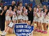 The Sacred Heart Academy basketball team celebrates after winning the SCC title on Monday at Quinnipiac University in Hamden.