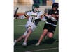 Hamden senior Finn Purcell (11) tries to make his way past a Shelton defender in Thursday’s game at Hamden High School.