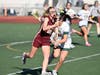 Junior co-captain Elizabeth Giammattei runs through the Hamden defense in Monday's game at Hamden High School.