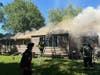 Crews operate at the scene of a fire on Okenuck Trail in Stratford on Monday morning.