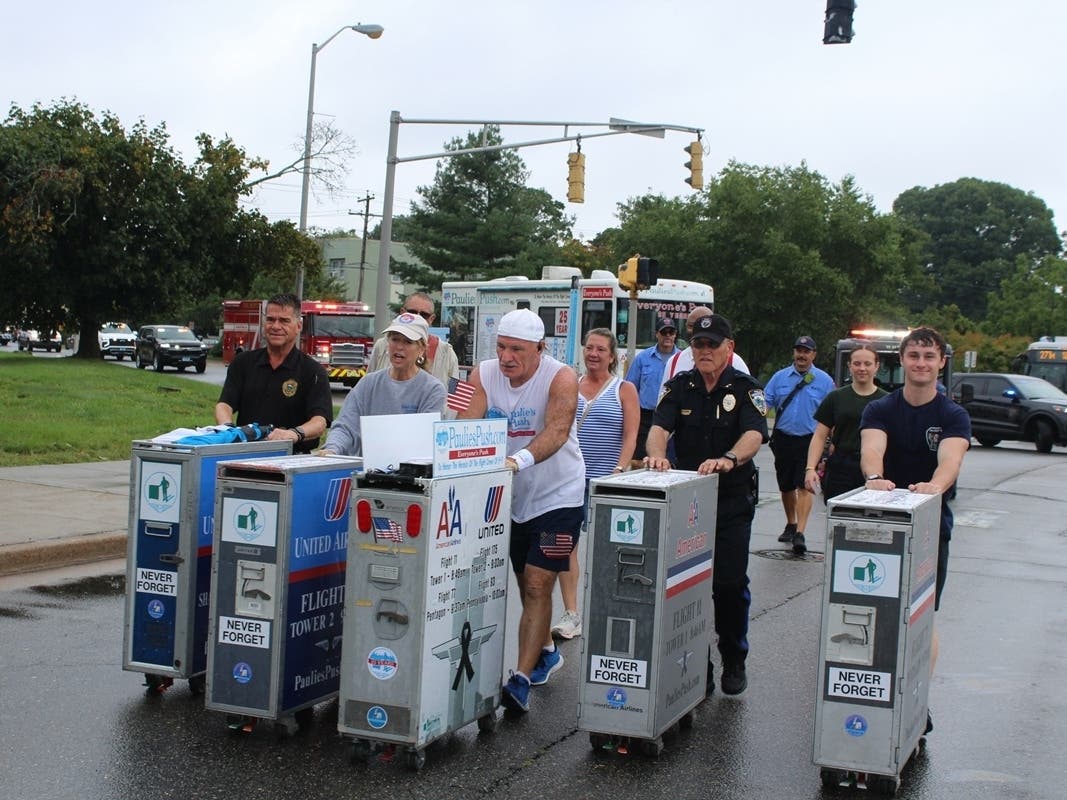 Paul “Paulie” Veneto, center, pushes his airline beverage cart alongside carts pushed by, from left, West Haven Fire Deputy Chief William S. Johnson IV, Mayor Dorinda Borer, Police Chief Joseph S. Perno and Allingtown volunteer firefighter Dylan Reaburn.