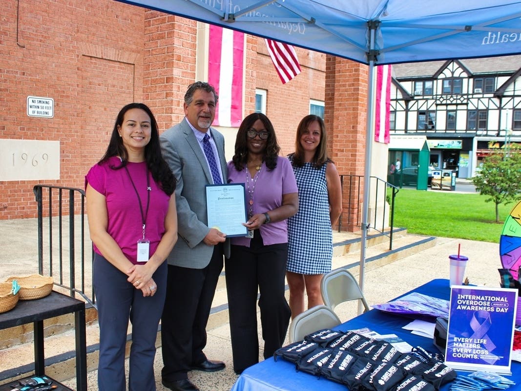 West Haven Human Resources Commissioner John M. Carrano presents a mayoral proclamation to Health Director Sheila Carmon on the front steps of City Hall declaring Overdose Awareness Day on Monday.