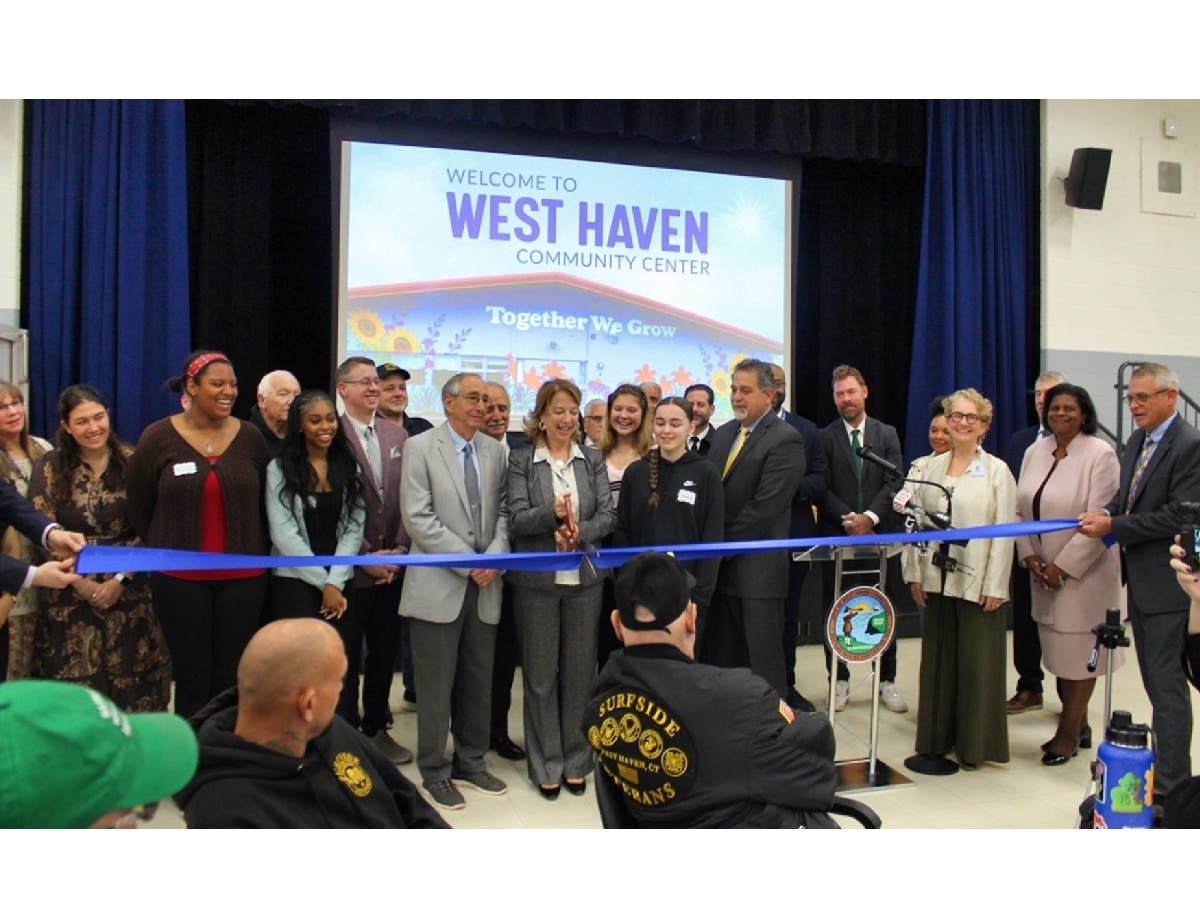 West Haven Mayor Dorinda Borer, with city officials, West Haven High School students and corporate sponsors, cuts the ribbon to mark the grand opening of the new West Haven Community Center at 255 Meloy Road on Thursday.