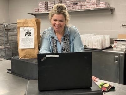 Kate Murphy helping students order their build-your-own-breakfast online.