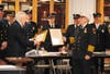 Mayor Tom Kelaher presents Richard Beck with proclamations from the town and the Ocean County freeholders. 
