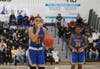 Serenity Anderson (right) watches as Leilani Correa shoots a free throw. Anderson had 5 points and 4 rebounds. 