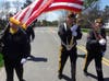 Members of the VFW lead a procession from the Angel in Anguish to Princeton Avenue to unveil the banners. 