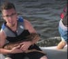 Kyle Mulholland holds the fawn. 