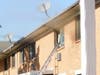 Smoke comes out of a window in the apartment complex. 