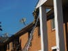 Firefighters climb onto the roof an through a window at the complex. 