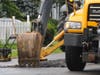 Loose dirt is removed from the hole that developed on Hooper Avenue Saturday in Toms River. 