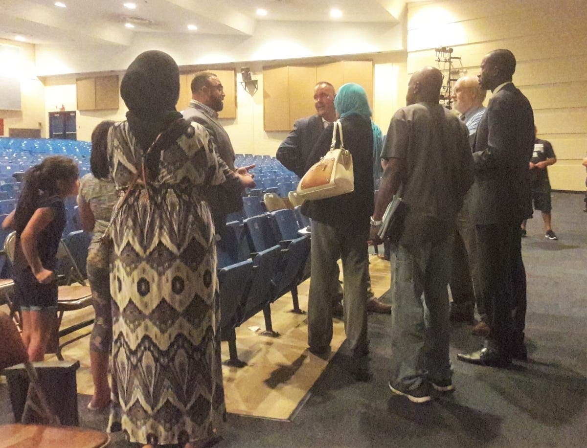 Toms River school board member Daniel Leonard (center) speaks with critics after Wednesday's Board of Education meeting.