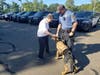 Donna Mitchell meets K9 Officer Echo and Patrolman Scott Smith, Echo's handler. Echo was the recipient of a K9 protective vest Mitchell donated in memory of her dog.