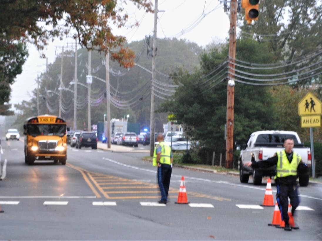 A school bus leaves Brick Memorial High School with students Tuesday afternoon following a lockdown prompted when a 16-year-old boy ran into the high school after being shot, police said. Dozens of law enforcement members responded. 