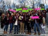 Toms River South students hold up signs with the hashtag #What We Lose at the Toms River South-Lakewood football game on Thanksgiving. District officials say all sports and clubs could be eliminated as a result of pending state funding cuts. 