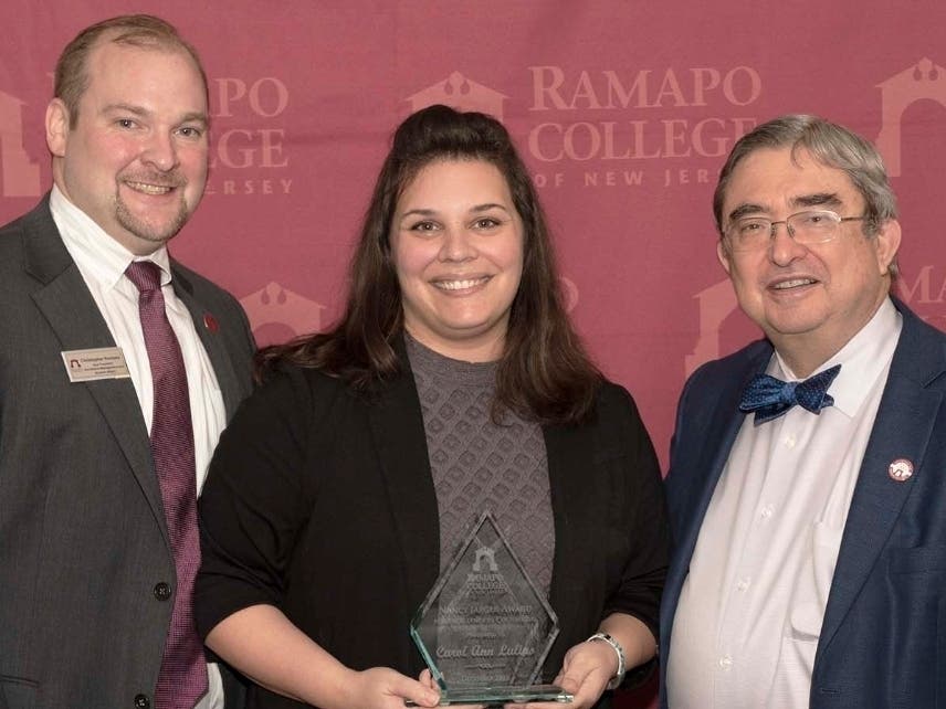 Christopher Romano (left), vice president for enrollment management and student affairs at Ramapo College; Carol Ann Lulias and Ramapo College President Peter P. Mercer, after Lulias was honored by the college.