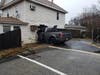 A pickup truck smashed into the living room of a Brick Township home on Tuesday, killing a woman who was on a bed.