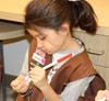 A Brownie Girl Scout practices good dental health on a model of teeth. 