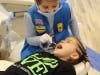 Girl Scouts get to learn about a dental exam as both doctor and patient. 