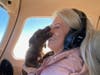 Inga Luria gets a kiss from a puppy on a recent FlyPups rescue flight. FlyPups transports puppies from kill shelters the South to New Jersey, where they find permanent homes. 