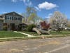 A massive tree trunk remains on the front lawn of a home in Toms River on Wednesday, after it was brought down by Tuesday's storm.