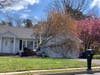 A tree leans on a home in Toms River on Wednesday, after it was brought down by Tuesday's storm.