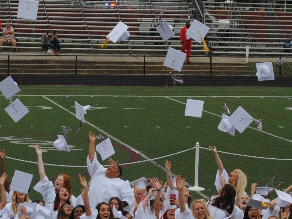 Toms River South students toss their caps at graduation in 2018. People around the state are pressing for in-person graduations in 2020.