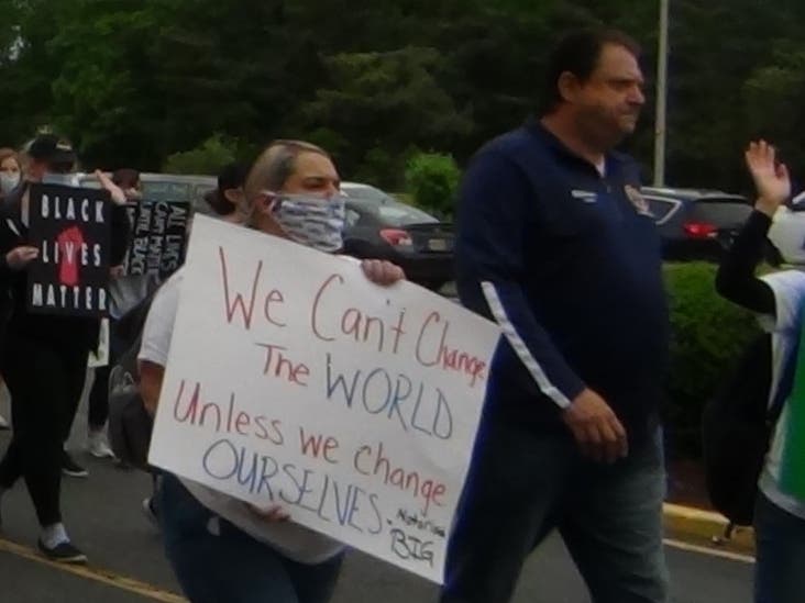 A woman marches in Toms River on Tuesday, next to Ocean County Prosecutor Bradley Billhimer, over the death of George Floyd. A protest in Lakewood is set for Saturday.