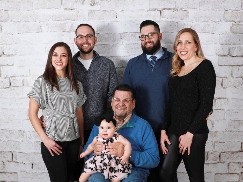 John Menna Sr., holding his granddaughter, was found slain in his Virginia home. His sons, Toms River residents, are left to pick up the pieces. left 