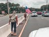Joshua Yajcaji (carrying flag) and De'Jon Farrell-Francis marched along Route 70 on Saturday to honor three veterans who died recently. 