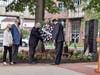 Freeholders Virginia Haines and Gary Quinn (left) watch as Freeholder Director Joseph Vicari and Ocean County Prosecutor Bradley Billhimer place a wreath at the county's Sept. 11 memorial in Toms River.