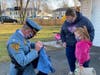 New Jersey State Police Superintendent Col. Patrick Callahan presents Sophia with her own state trooper uniform.