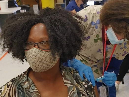 Kim Payton, a staff member at Manchester Township High School, receives her first inoculation with the COVID-19 vaccine, part of a collaboration between Manchester Schools and the Ocean County Health Department.​