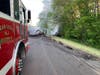 Firefighters extinguish the car fire after a BMW went through guardrails on the southbound shoulder of the Garden State Parkway on Monday. 