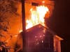 Flames shoot from the roof of a home in the East Dover section early Tuesday. There were no injuries. 