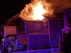 Firefighters battle the fire at an East Dover home early Tuesday morning. 