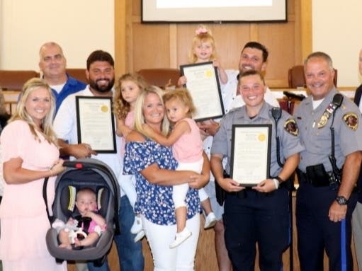Christopher and Joseph Drago and their families, and Patrol Officer Bridget Badalis with Toms River Police Chief Mitch Little at Tuesday's Township Council meeting. 