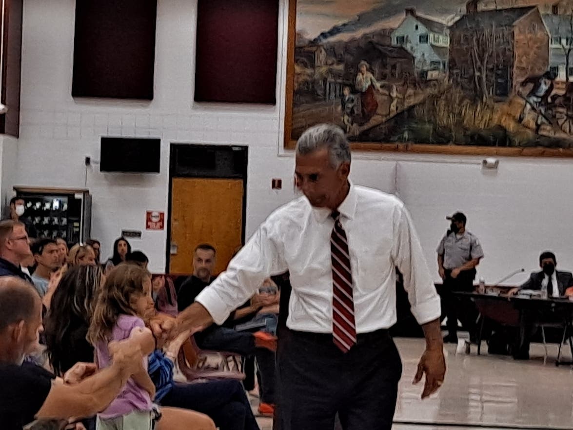 Jack Ciattarelli, the Republican challenging Phil Murphy for governor, fistbumps a resident at the Toms River Regional Board of Education Wednesday night. Ciattarelli told the board it should give parents a choice on whether their children wear masks. 