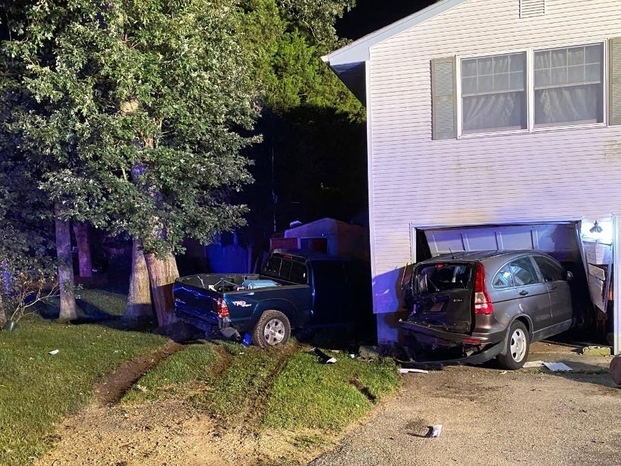A Toyota Tacoma knocked a Honda CR-V into a home and hit a shed after it was rear-ended in a crash Monday, police said.