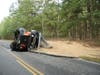 Police said the dump truck ran onto the dirt shoulder, crossed the road and overturned. 