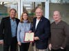 Toms River Mayor Maurice "Mo" Hill presents a certificate commemorating the naming of the building at 54 Washington Street in honor of Al Dietrich to his children (from left) Darren, Debbie Schwartz, and Doug; son Darren was in the audience.