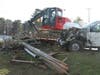 The trailer with a John Deere excavator jackknifed and hit the truck after it ran off the road, police said. 