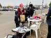 Ukrainians pick up some needed items at a border crossing in Poland, where refugees have come to flee the Russian invasion. 