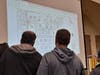 Residents look at the proposed plans for a 59-home development on 30 acres of land in Breton Woods.